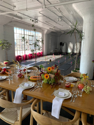 Creative floral tablescape with fruits and vibrant flowers by Wildstems