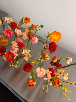 Yellow and orange flowers in bud vases