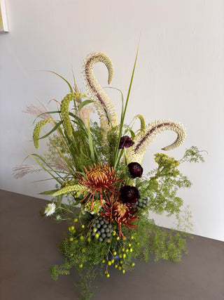 Green and burgundy flower arrangement