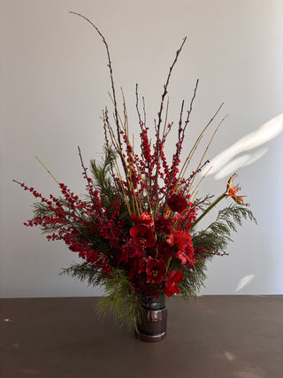 Festive floral arrangement in green and red flowers