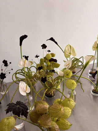 Modern and sculptural event florals in white, black and green