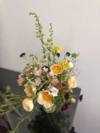 Bouquet of flowers on a reflective surface with a neutral background