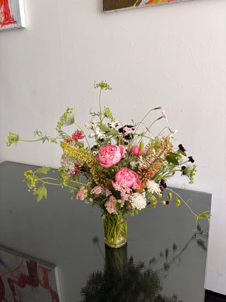 Bouquet of flowers on a reflective surface with a neutral background