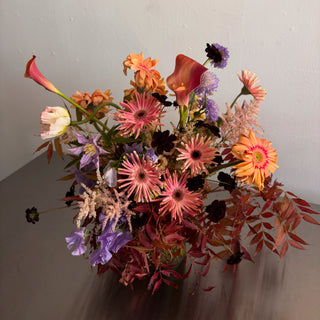 Bouquet of colorful flowers on a white surface with a light gray background