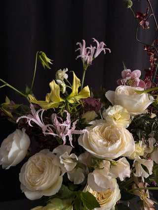 Bouquet of white and light-colored flowers on a dark background