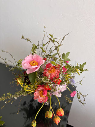 Bouquet of peonies and premium flowers on a gray surface