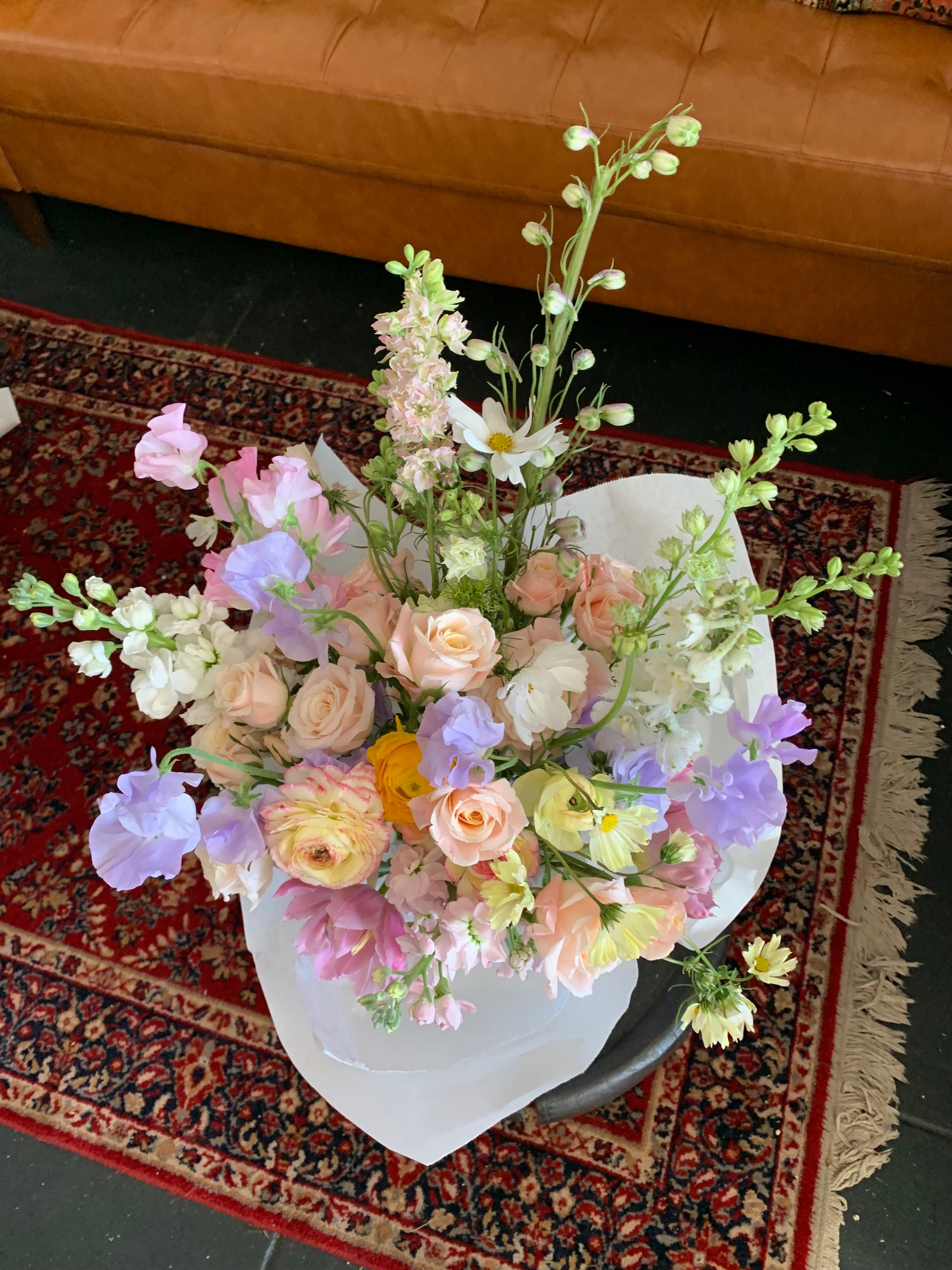 Soft and gentle floral arrangement with locally grown ranunculus, beautiful spray roses, lavender sweet peas, tulips and other seasonal flowers. Wildstems Los Angeles