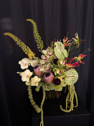 Luxurious greens orchids, anthuriums, proteas and amaranth flower arrangement for delivery in los angeles by wildstems