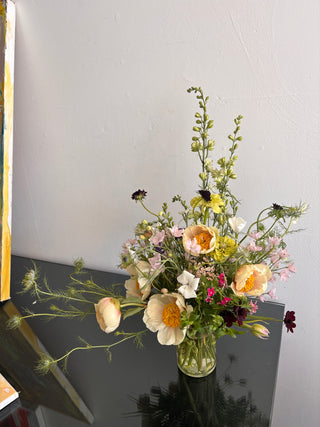 Peonies and wildflowers bouquet on a table