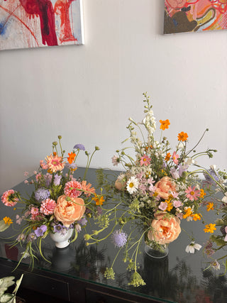 Peonies and wildflowers arrangements on a table