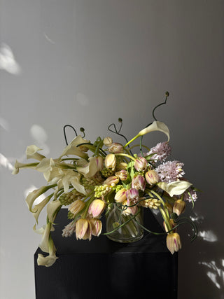 Bouquet of flowers on a reflective surface with a dark background