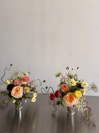 dinner centerpieces in silver vases for events in Los Angeles by Wildstems: garden roses, ranunculus, seasonal wildflowers and curly onion for events