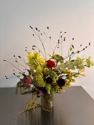 Bouquet of green flowers with greenery and red berries on a white background
