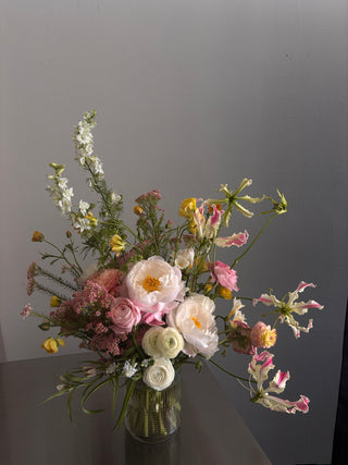Bouquet of flowers with pink, white, and yellow colors on a gray background