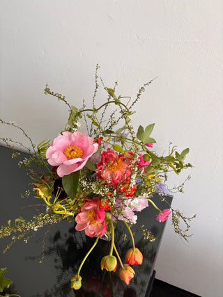 Bouquet of flowers on a dark surface with a white background