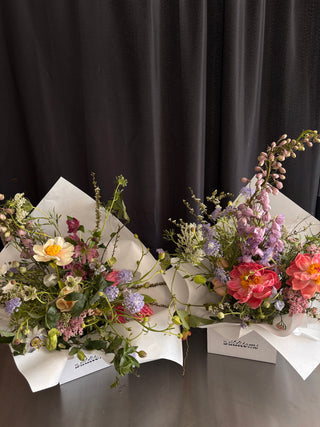 Bouquet of flowers with white ribbons on a dark background
