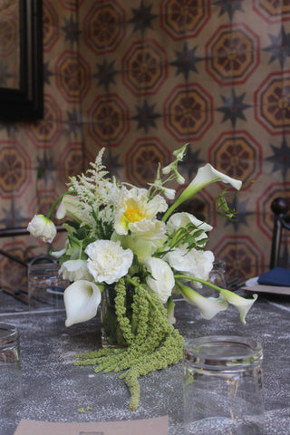 white and green event florals in Los Angeles. modern centerpiece with white Cala lilies, white flowers and green amaranth by Wildstems