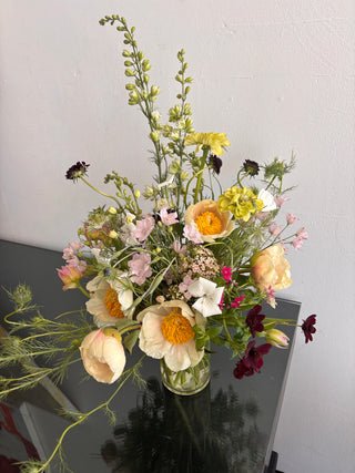 Bouquet of flowers on a reflective surface with a neutral background