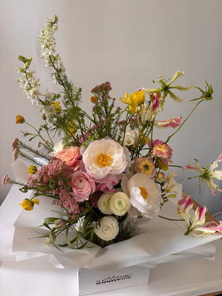 Bouquet of flowers with white, pink, and yellow colors on a plain background