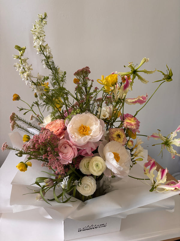 Bouquet of flowers with white, pink, and yellow colors on a plain background